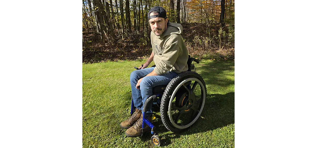 Zac in his Quickie Nitrum wheelchair with Empulse M90 power assist wheels