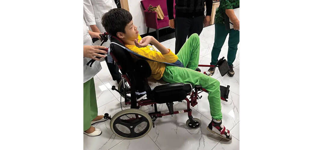 Akpeil in her old wheelchair